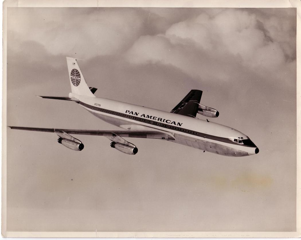 An early Pan Am 707 in-flight with pipe noise deflectors on the back of each engine.